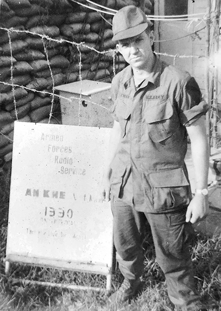 Don in front of sign
